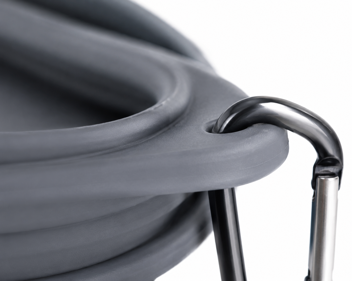 Overmoulded 6061 aluminium carabiner — embedded during injection, no seams or crevices between clip and bowl